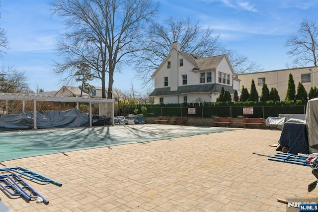 view of swimming pool with a patio, fence, and a pergola