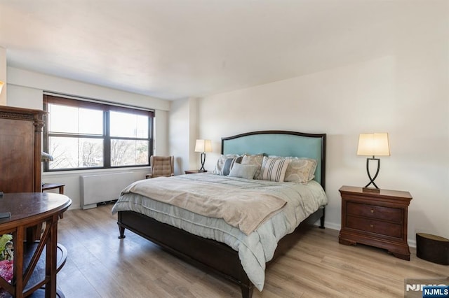 bedroom with baseboards and light wood-style flooring