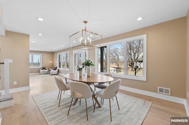 dining room featuring visible vents, baseboards, light wood-type flooring, recessed lighting, and a notable chandelier