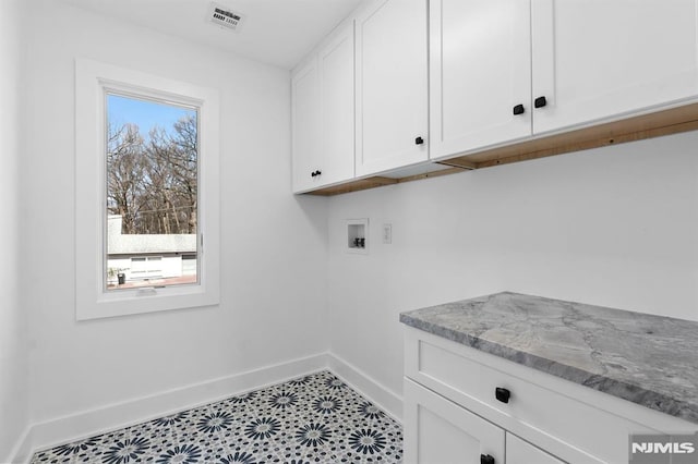 laundry room featuring hookup for a washing machine, visible vents, baseboards, cabinet space, and tile patterned floors