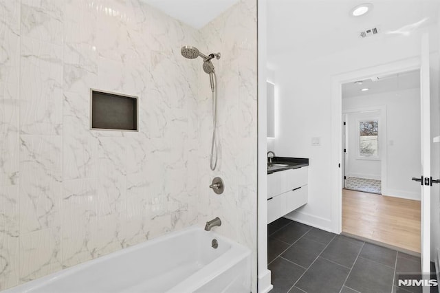 bathroom with visible vents, baseboards, tile patterned floors, vanity, and  shower combination