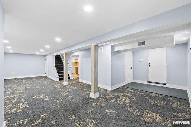 finished below grade area featuring stairway, recessed lighting, visible vents, and baseboards