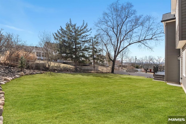 view of yard with a wooden deck and fence