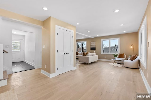 living room featuring recessed lighting, light wood-type flooring, and baseboards