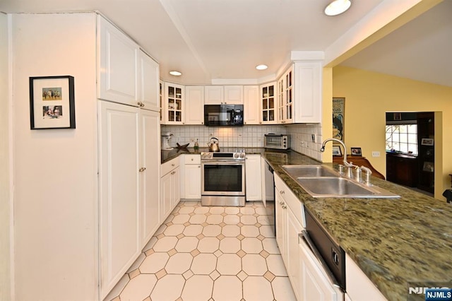 kitchen featuring stainless steel range with electric stovetop, tasteful backsplash, black microwave, and a sink