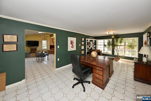 office space with crown molding, light floors, baseboards, and ceiling fan