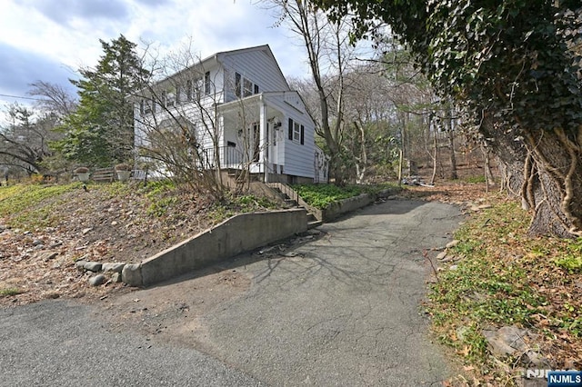 view of side of property featuring aphalt driveway