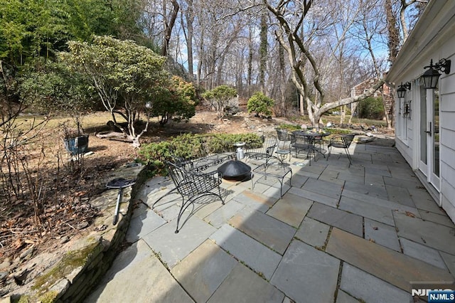 view of patio / terrace featuring outdoor dining area and an outdoor fire pit