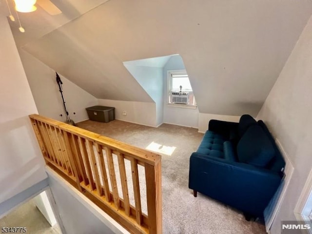 interior space featuring carpet flooring, ceiling fan, and vaulted ceiling