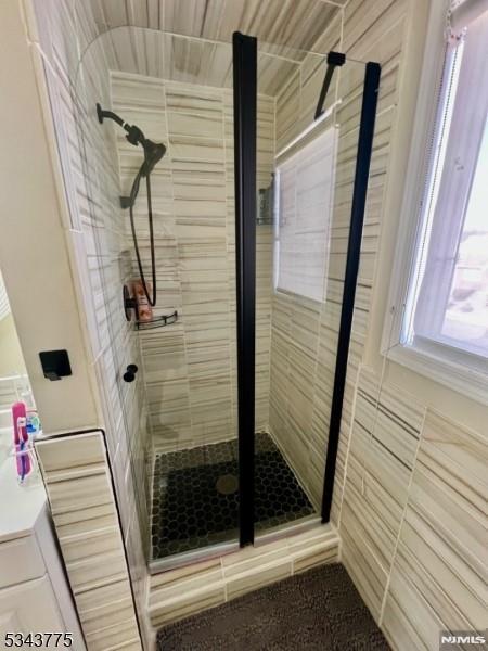 full bath featuring a shower stall