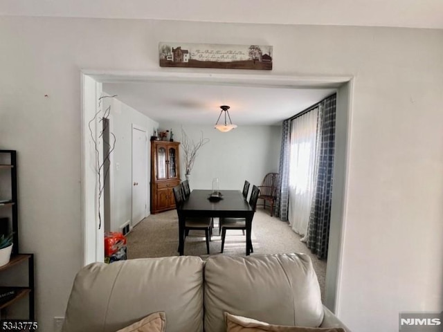 dining room featuring light colored carpet