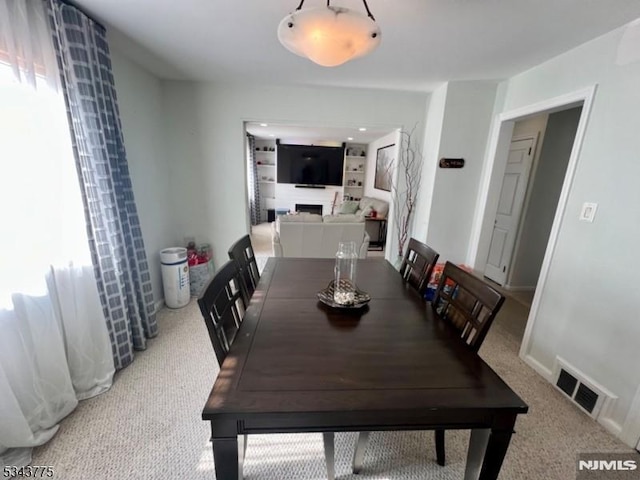 dining area featuring visible vents, baseboards, and carpet