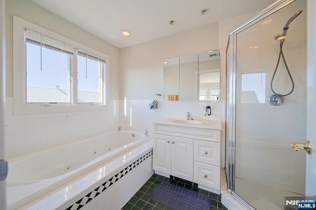 full bathroom with vanity, a tub with jets, recessed lighting, a stall shower, and tile patterned floors