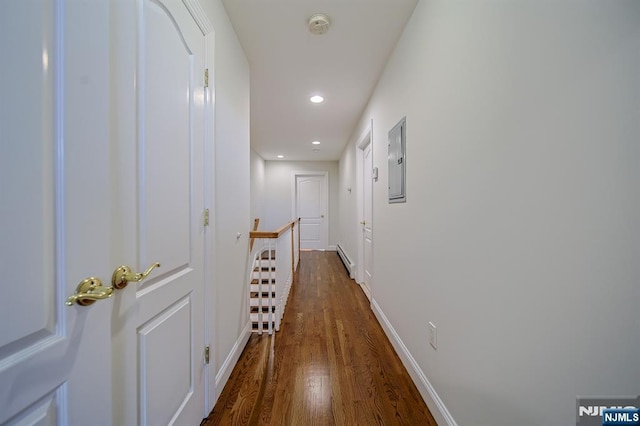 hallway featuring an upstairs landing, electric panel, a baseboard radiator, baseboards, and dark wood-style flooring