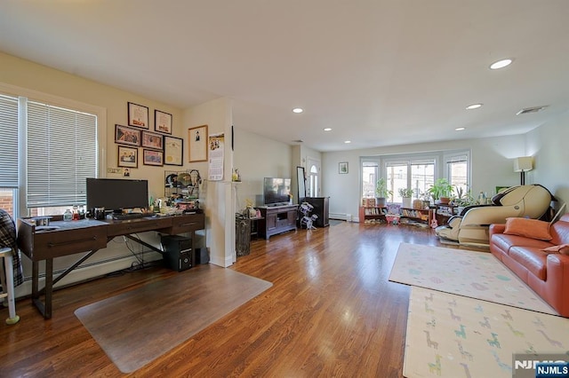 office featuring recessed lighting, wood finished floors, and a baseboard radiator