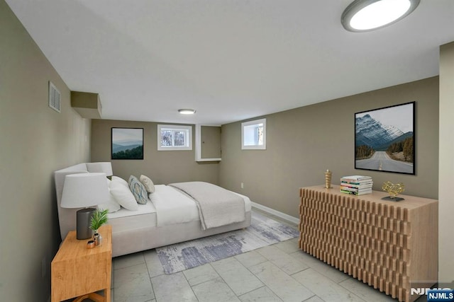 bedroom featuring visible vents, marble finish floor, and baseboards