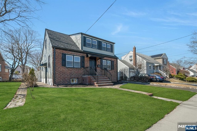 bungalow-style home featuring brick siding and a front yard