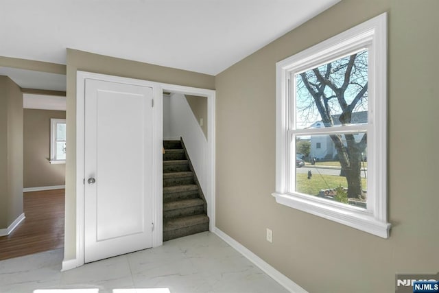 stairs with baseboards and marble finish floor