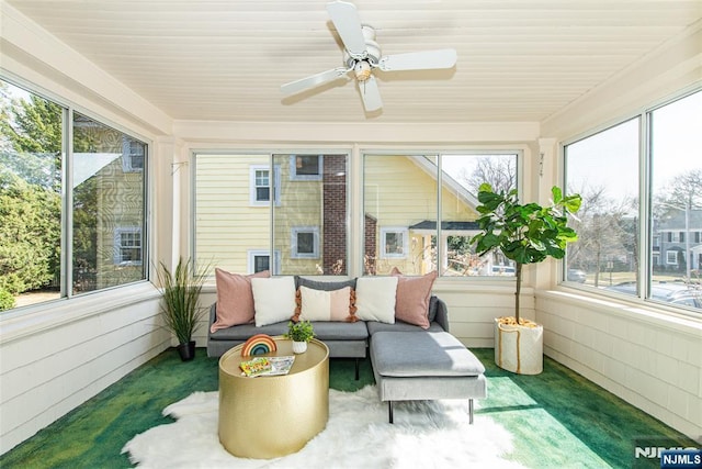 sunroom / solarium with a ceiling fan