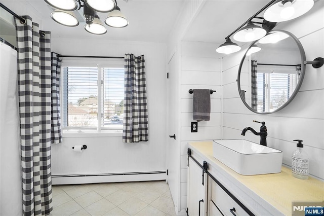 full bathroom with vanity, a shower with curtain, tile patterned floors, baseboard heating, and a chandelier