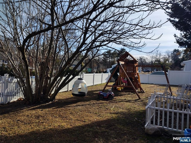 view of yard featuring a playground and a fenced backyard