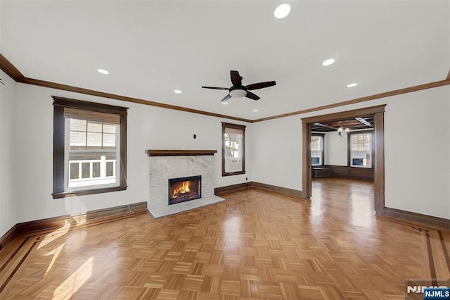 unfurnished living room featuring a wealth of natural light, recessed lighting, baseboards, and a ceiling fan