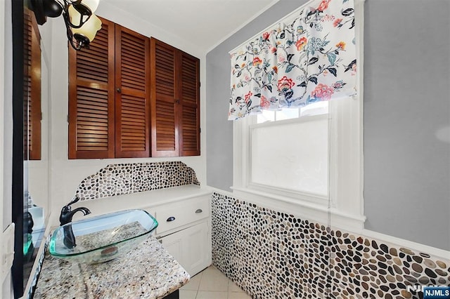 bathroom with tile patterned flooring and a sink