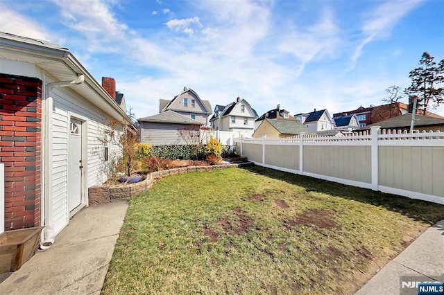 view of yard with fence and a residential view