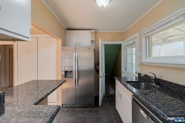 kitchen featuring a sink, appliances with stainless steel finishes, white cabinets, and crown molding