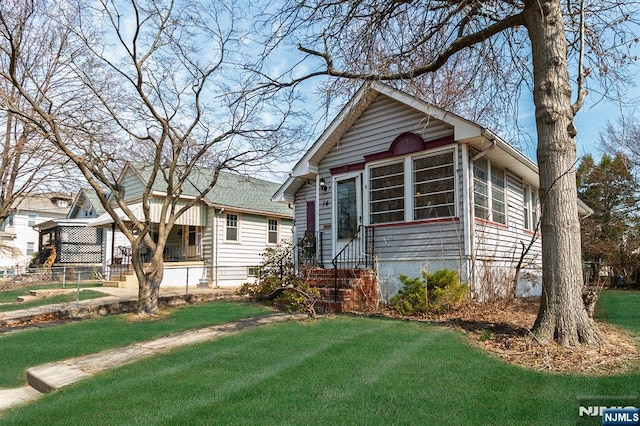 view of front of home featuring entry steps and a front lawn