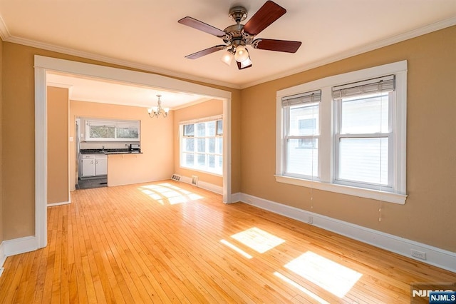 unfurnished living room with light wood finished floors, ceiling fan with notable chandelier, crown molding, and baseboards