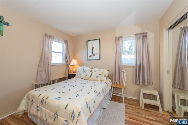 bedroom with baseboards and wood finished floors