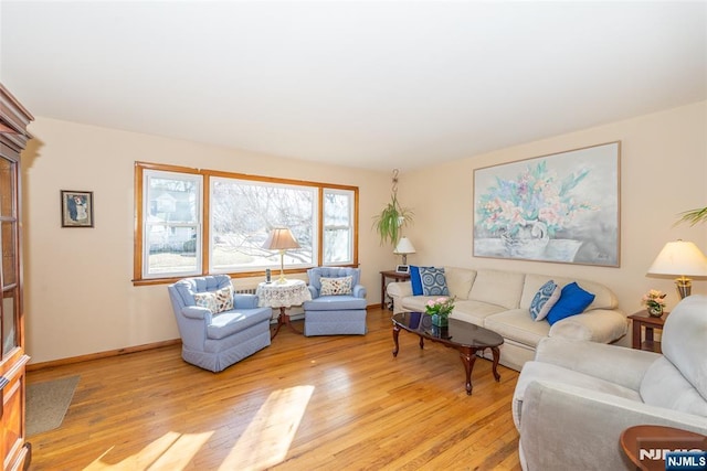 living room with light wood-style flooring and baseboards