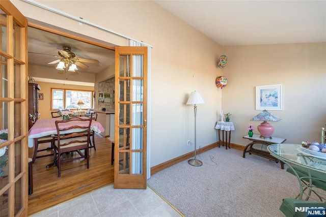 interior space featuring tile patterned floors, baseboards, and ceiling fan