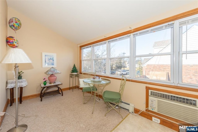 sitting room with baseboards, an AC wall unit, lofted ceiling, carpet floors, and a baseboard radiator