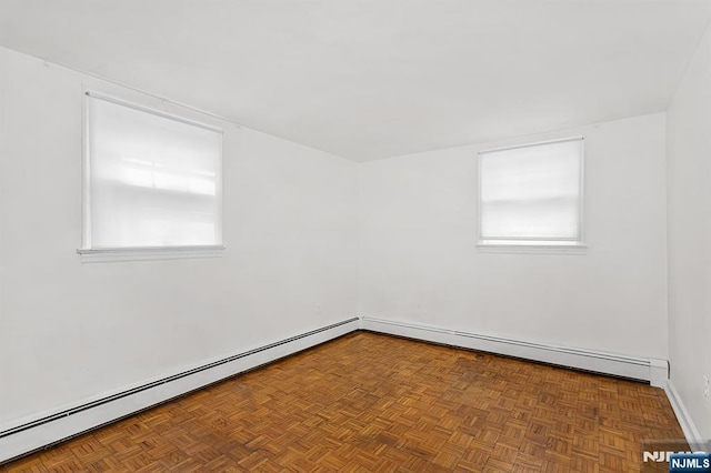 unfurnished room featuring baseboard heating