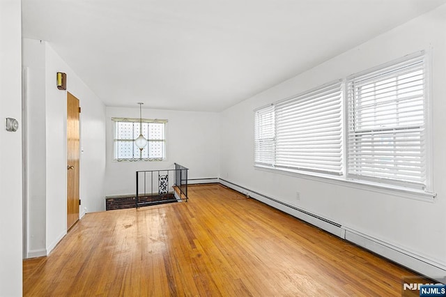 spare room with plenty of natural light and baseboard heating