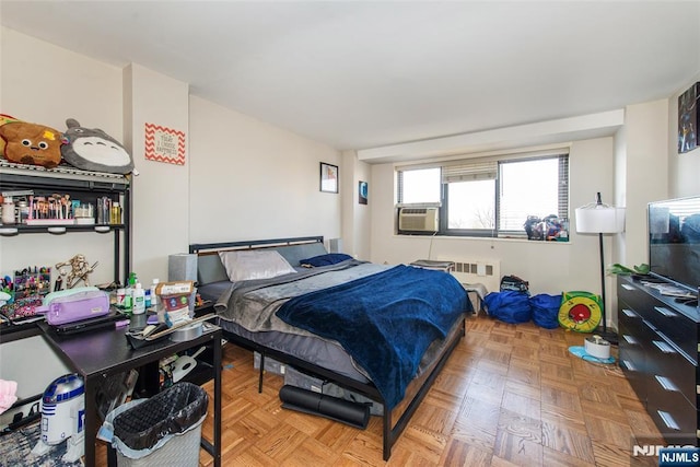 bedroom featuring cooling unit and radiator heating unit