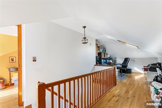 office space with lofted ceiling, wood finished floors, and baseboards