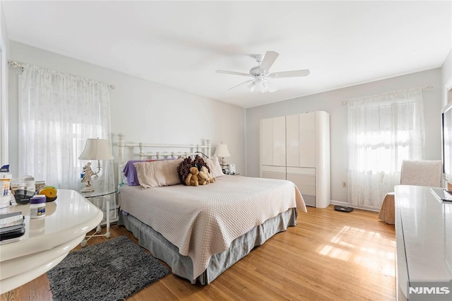 bedroom with light wood-type flooring and a ceiling fan