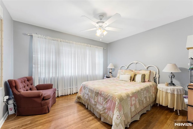 bedroom featuring ceiling fan and light wood finished floors