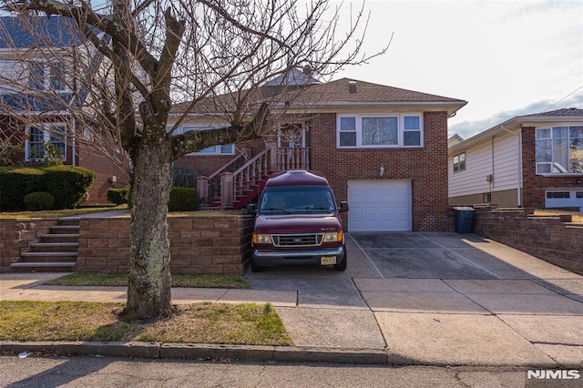 view of front of home featuring brick siding, driveway, stairs, and a garage