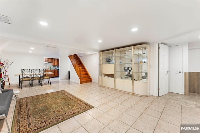 interior space featuring light tile patterned flooring, recessed lighting, and visible vents