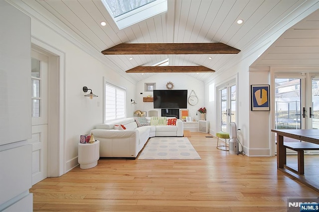 living room with baseboards, lofted ceiling with skylight, light wood-style floors, and wooden ceiling