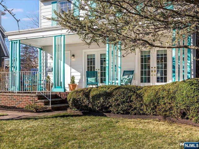 back of property with french doors and a yard