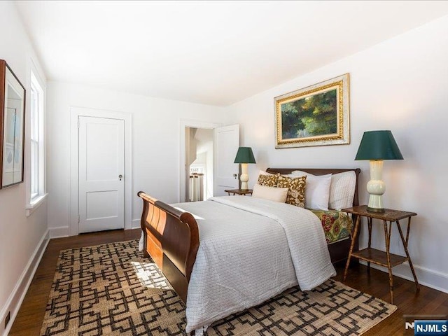 bedroom featuring baseboards and wood finished floors