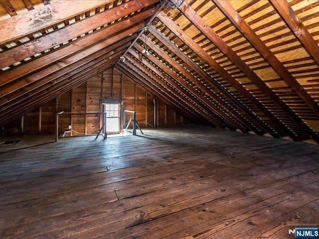 unfinished attic with an upstairs landing