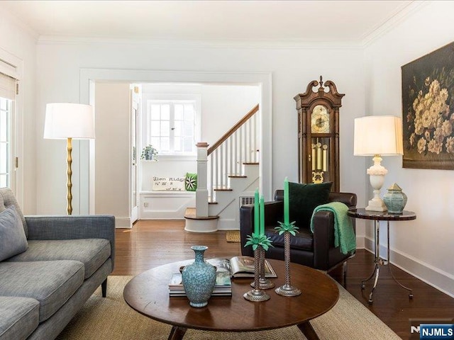 living room featuring stairway, wood finished floors, and ornamental molding