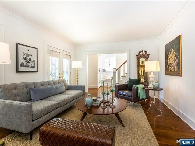 living area featuring stairs, crown molding, wood finished floors, and baseboards