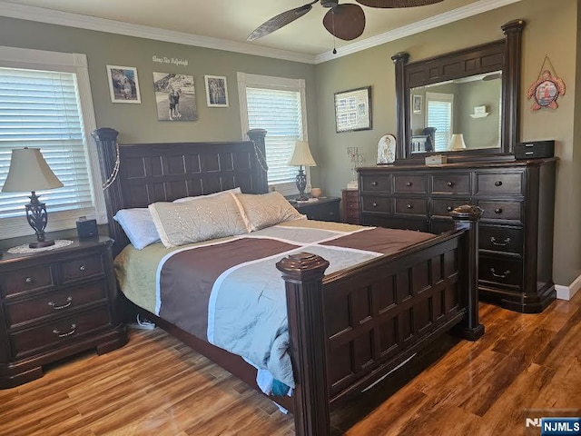 bedroom featuring wood finished floors, ornamental molding, and a ceiling fan